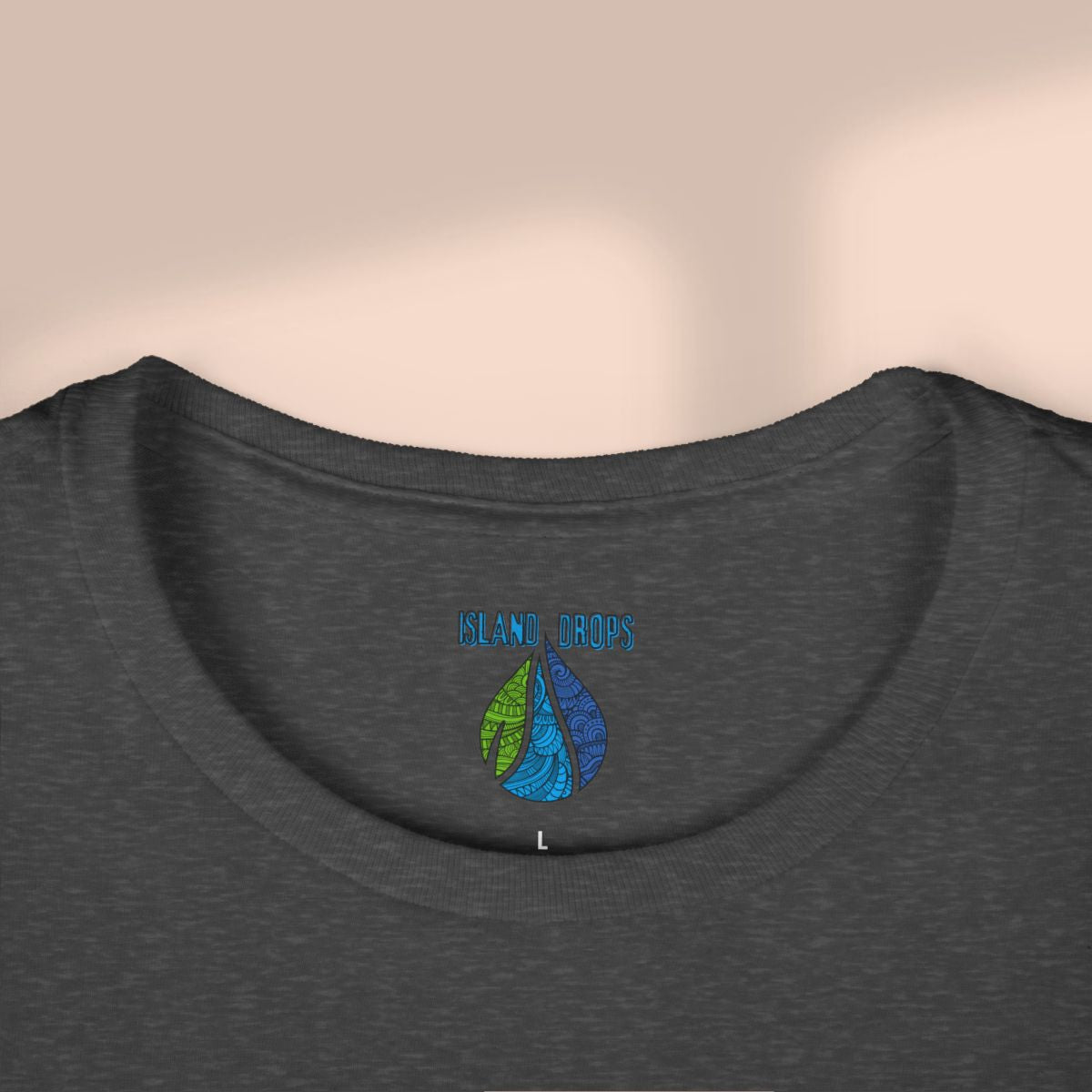 Dark gray t-shirt with colorful 'Island Drops' logo on a beige background