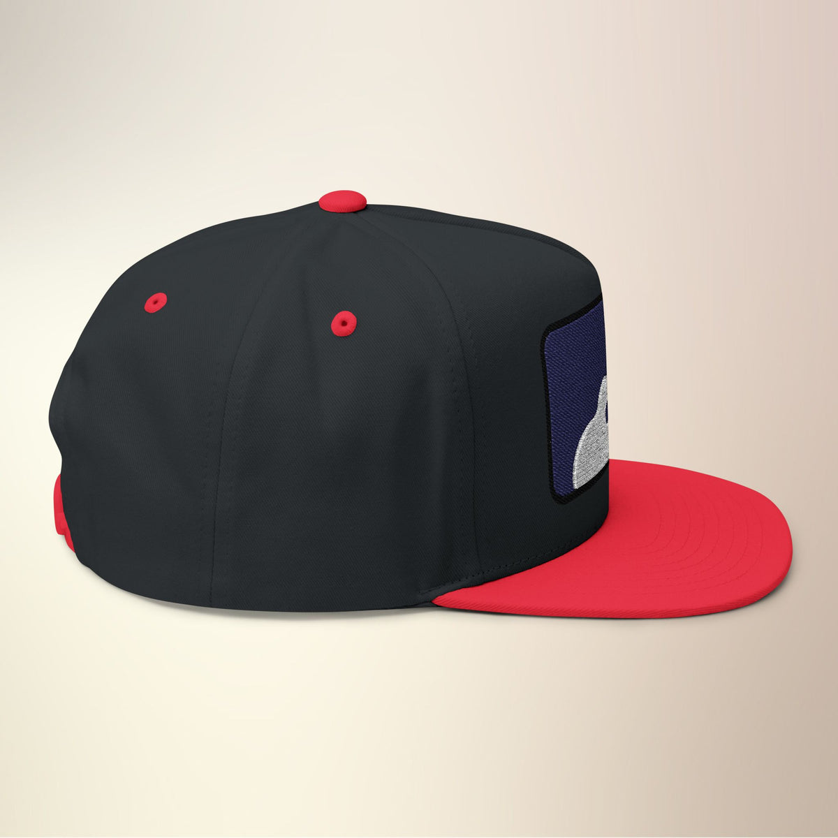 Side view of black ukulele patch snapback with red brim and eyelets
