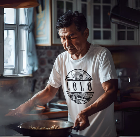 Man cooking in a kitchen wearing a white t-shirt with 'LOLO', meaning grandpa, graphic design t-shirt  - Island Drops t-shirt collection | Unisex t-shirts