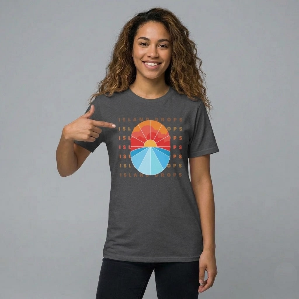 Person wearing a dark gray t-shirt  with 'ISLAND DROPS' text behind a graphic sunset - Island Drops t-shirt collection | Unisex t-shirts