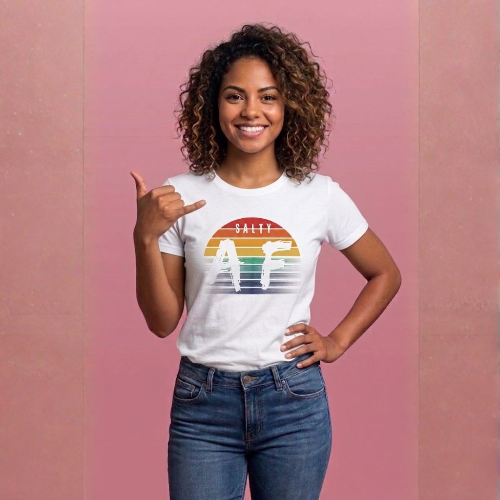 Woman wearing a white t-shirt with 'SALTY AF', graphic design and rainbow sunset  - Island Drops t-shirt collection | Unisex t-shirts
