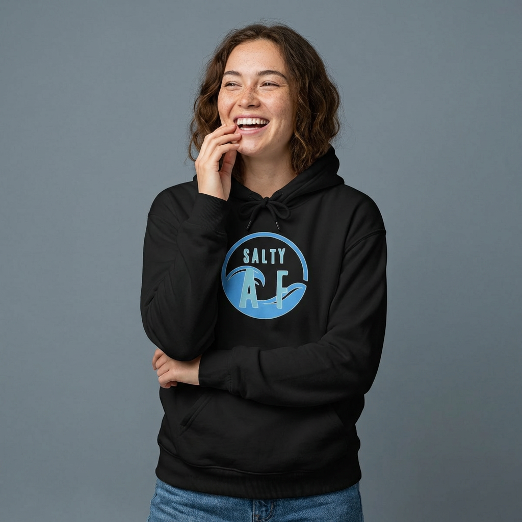 Person wearing a black hoodie with 'SALTY AF' text graphic design - Island Drops hoodie collection | Unisex pullover