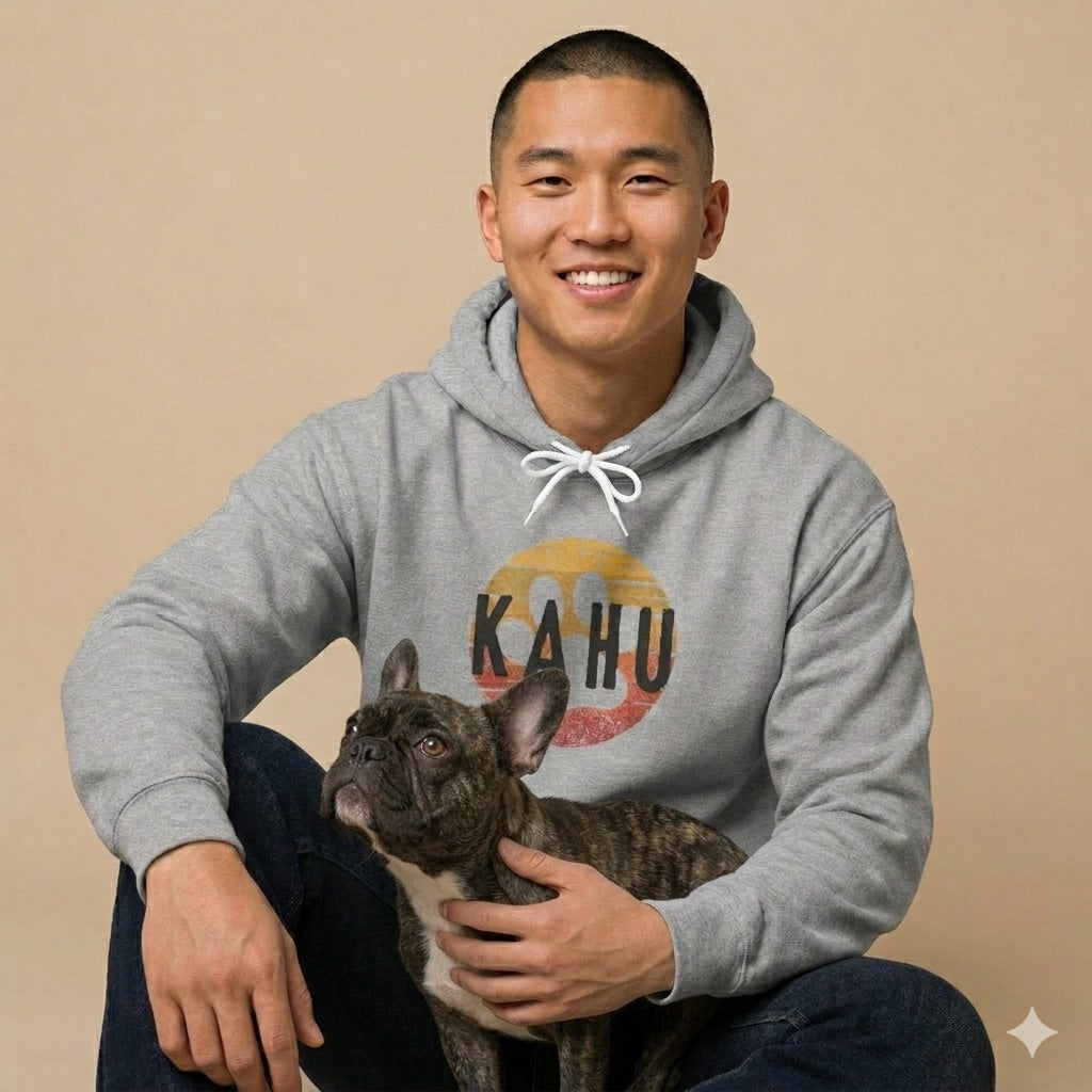 Man with his French bulldog, wearing a gray hoodie with 'KAHU' graphic design - Island Drops hoodie collection | Unisex pullover