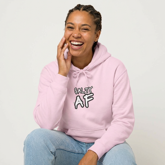 Person wearing a pink hoodie with 'SALTY AF' text graphic design - Island Drops hoodie collection | Unisex pullover