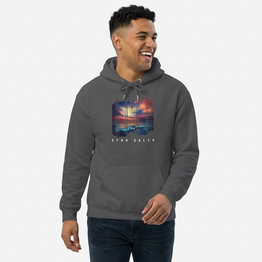 Man wearing a gray hoodie with a stylized beach sunset graphic and 'STAY SALTY' text - Island Drops hoodie collection | Unisex pullover