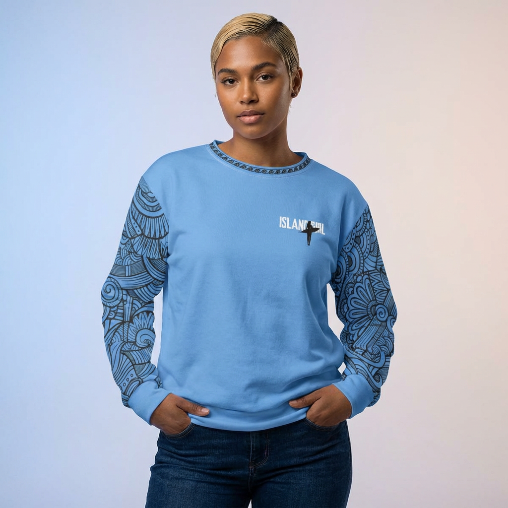 Person wearing a blue sweatshirt with 'ISLAND GIRL' text behind a graphic surfer girl and tribal tattoo sleeve pattern - Island Drops long sleeve collection | Unisex sweatshirt
