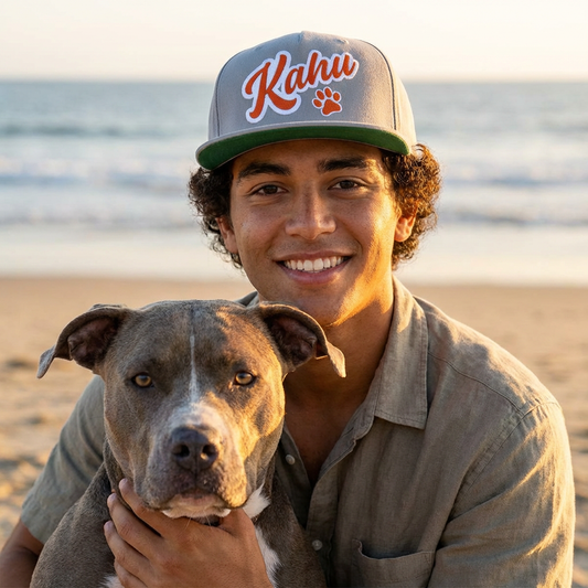 Man wearing a gray cap with 'Kahu' and paw print graphic design - Island Drops hat collection | Unisex snapback hat