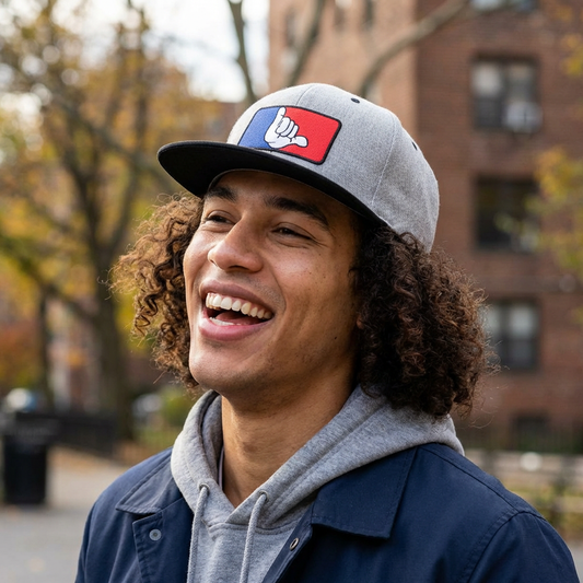 Person wearing a gray and black cap with a hang loose graphic design - Island Drops hat collection | Unisex snapback cap